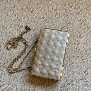 Sondra Roberts gold clutch.